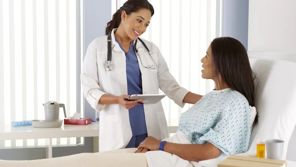 A doctor communicates softly with a patient.